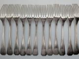 a lot of forks that are sitting on a table