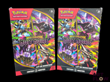 two packs of pokemon trading cards are shown on a black background
