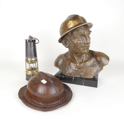 a statue of a man with a hat next to a lighter