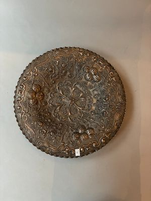 une plaque en argent accrochée au mur, sur laquelle est fixée une étiquette