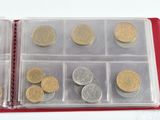 many coins in a plastic case on the table