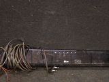 a remote control sitting on the ground next to a bunch of wires