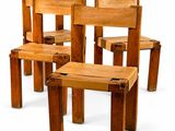 four wooden chairs sitting next to each other on a white surface