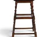 an old wooden stool with a shelf on top of it