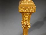 a gold lamp that is sitting on a table