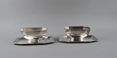 pair of silver plated tea cups and saucers on trays