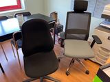 two office chairs sitting next to each other in a room