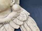 a statue of an angel with wings on it ' s head