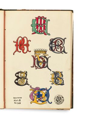 an open book with a drawing of letters and symbols on it