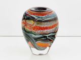 a glass vase with a multicolored design on it