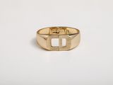 a close up of a gold ring on a white surface