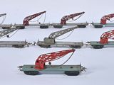 a lot of toy train cars with a crane on them