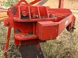 a red machine that is sitting in the grass