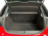 the back of a red car with its trunk open showing the trunk space