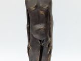 an image of a bronze statue of a man standing on a wooden base