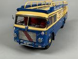 a blue and yellow fire truck on a gray surface