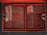 a wooden box filled with lots of forks and spoons