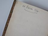 an old book with writing on it sitting on top of a table