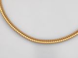 a close up of a gold necklace on a mannequin mannequin mannequin mannequin mannequin mannequin mannequin manne