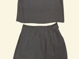 the top and skirt are made of black and white polka dot fabric