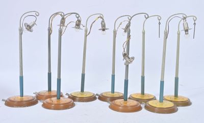 seven pairs of surgical instruments on display on a white surface