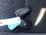 a car key and a remote control on the back seat of a car