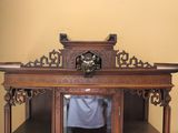a wooden cabinet with a clock on top of it