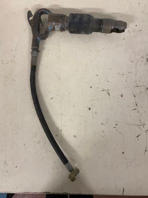 a close up of a hose attached to a wall on a tiled floor
