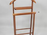 a wooden coat rack with a coat hanger on it