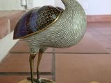 a statue of a bird that is on a table