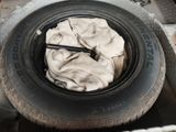 a tire with a cloth on it in the back of a truck
