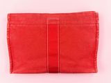 a red purse with a white stripe on it