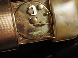 a close up of a metal object on a black surface