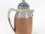 a brown and blue tea pot with a lid