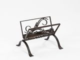 an iron and wood magazine rack with a bird design on it