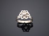 a white gold and diamond ring with a flower design