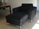 a black chair and a black ottoman in a living room