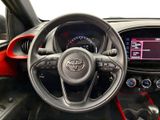 the interior of a red and black sports car with a steering wheel