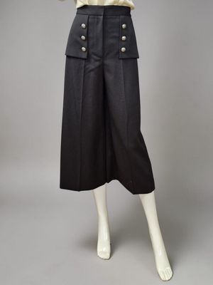a woman ' s black skirt with buttons and buttons on the waist
