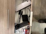 a cabinet with a keyboard, mouse, and other items in it