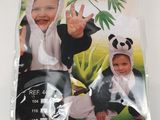 a baby in a panda costume on a white table