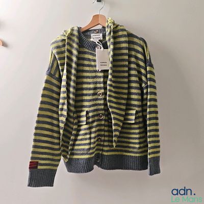 yellow and grey striped cardigan sweater hanging on a hanger