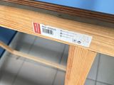 a wooden table with a label on it in a room