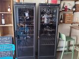 bottles of wine are lined up in a wine cooler in a room