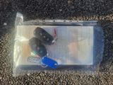 a bag of keys and a car key on the ground