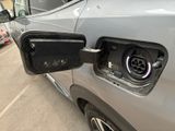 a car that has a plugged in charging station attached to it
