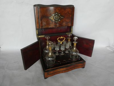 a small wooden box with a set of glass bottles in it
