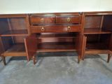 a wooden cabinet with two drawers and a shelf