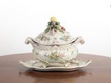 a picture of a tureeny dish with a lid on a wooden table