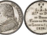 a silver coin with a portrait of a man on it